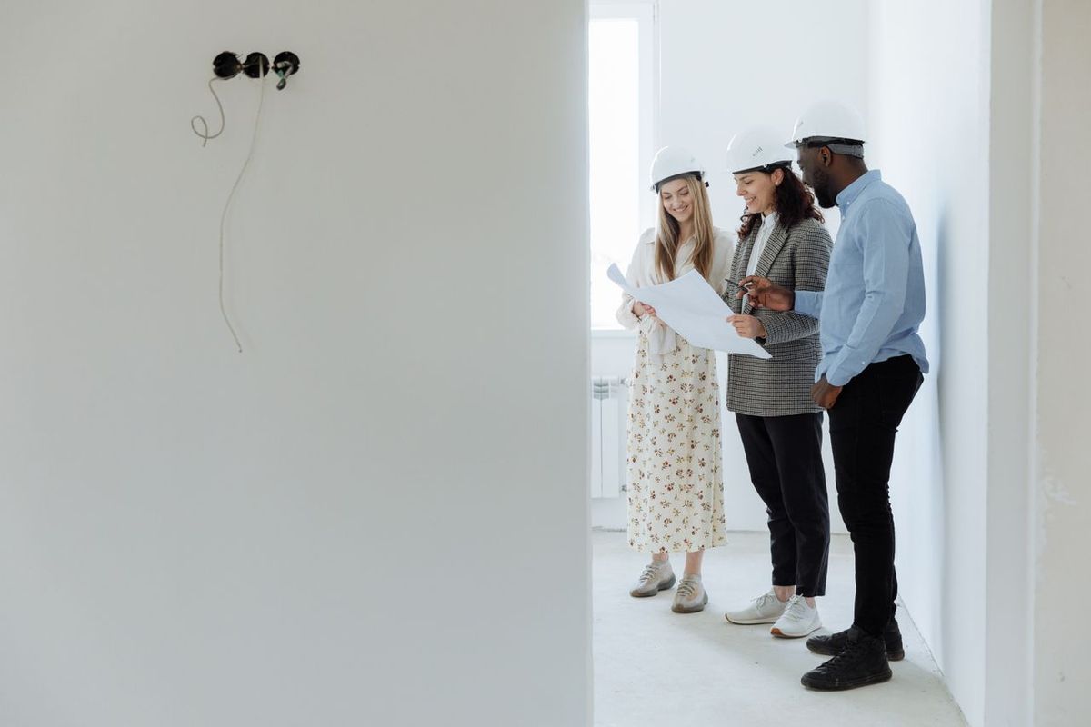 Team reviewing renovation plans on site